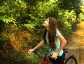 Teen girl cycling through vietnam jungle hill Royalty Free Stock Photo