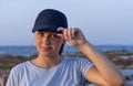 Teen girl in dark blue baseball cap and t-shirt Royalty Free Stock Photo