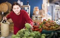 Teen girl decided to buy fresh artichoke