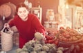 Teen girl decided to buy fresh artichoke