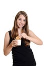 Teen girl dunking oatmeal cookie in milk