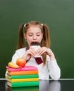 Teen girl eating chocolate at lunchtime