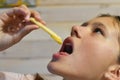 Girl eating delicious fast food hamburger with fries