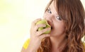 Teen girl eating green apple Royalty Free Stock Photo