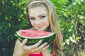Teen girl is eating watermelon over grass Royalty Free Stock Photo
