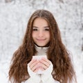 Teen girl enjoying big mug of hot drink during cold day Royalty Free Stock Photo