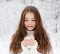 Teen girl enjoying big mug of hot drink during cold day Royalty Free Stock Photo