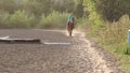 Teen girl with excess weight rides a brown horse.