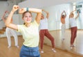 Teen girl with family doing aerobics exercises with group of people in dance center Royalty Free Stock Photo