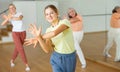 Teen girl with family doing aerobics exercises with group of people in dance center Royalty Free Stock Photo
