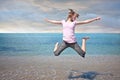 Teen girl freedom jump in water Royalty Free Stock Photo