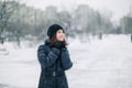 Teen girl froze. The child warms, hands clasped to his face. Portrait of a beautiful girl.