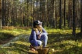 Teen girl gathers mushrooms for a walk in the summer or autumn forest Royalty Free Stock Photo