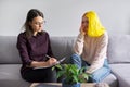 Teen girl giving interview to social worker. School psychologist talking with student Royalty Free Stock Photo