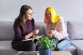 Teen girl giving interview to social worker. School psychologist talking with student Royalty Free Stock Photo