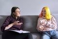 Teen girl giving interview to social worker. School psychologist talking with student Royalty Free Stock Photo
