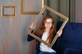 Teen girl with glasses holding an empty picture frame. Royalty Free Stock Photo