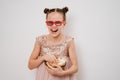 teen girl with glasses to watch funny 3D movies eats popcorn against white wall. Royalty Free Stock Photo