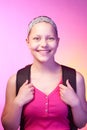 Teen girl goes to school with a backpack on her back Royalty Free Stock Photo