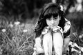 Teen girl in the grass in the park. Black and white photo. Royalty Free Stock Photo