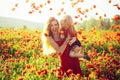 Teen girl and happy little boy child with flower red poppy, summer vacation, family, mothers day, childhood. Royalty Free Stock Photo