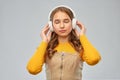 Teen girl in headphones listening relaxing music