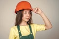 teen girl in helmet and boilersuit. child wear hard hat. kid builder on construction site. worker engineer. architect in
