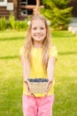 Teen girl holding basket with berry Royalty Free Stock Photo