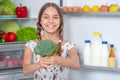 Girl with food near fridge Royalty Free Stock Photo