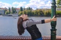 Teen girl holding pole, closed eyes, side face