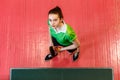 Teen girl holding a table tennis racket, top view