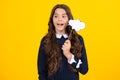 Teen girl holding thinking bubble, comment cloud over yellow background. Excited face. Amazed expression, cheerful and Royalty Free Stock Photo