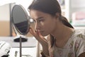 Teen girl at home doing makeup in front of the mirror, lifestyle Royalty Free Stock Photo