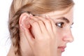 Teen girl inserting a hearing aid Royalty Free Stock Photo