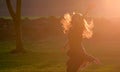 Teen girl jump against sunset in forest Royalty Free Stock Photo