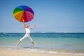 Teen girl jumping on the beach at blue sea shore in summer vaca Royalty Free Stock Photo