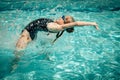 Teen girl jumping in the swimming pool Royalty Free Stock Photo