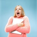 Teen girl with laptop. Love to computer concept. Attractive female half-length front portrait, trendy blue studio Royalty Free Stock Photo