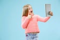 Teen girl with laptop. Love to computer concept. Attractive female half-length front portrait, trendy blue studio