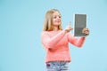 Teen girl with laptop. Love to computer concept. Attractive female half-length front portrait, trendy blue studio Royalty Free Stock Photo