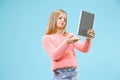 Teen girl with laptop. Love to computer concept. Attractive female half-length front portrait, trendy blue studio Royalty Free Stock Photo