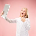 Teen girl with laptop. Love to computer concept. Attractive female half-length front portrait, trendy pink studio Royalty Free Stock Photo