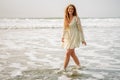 Teen girl laughing in the waves