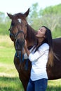 A teen girl laughs with her horse Royalty Free Stock Photo