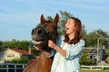 A teen girl laughs with her horse Royalty Free Stock Photo