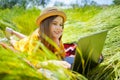 Teen girl learns working on laptop lying on meadow. mobile Internet in rural