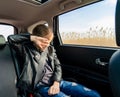 Teen girl in leather jacket crying seat back car