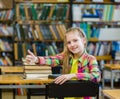 Teen girl in library showing thumbs up Royalty Free Stock Photo
