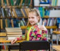 Teen girl in library showing thumbs up Royalty Free Stock Photo