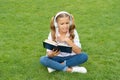 teen girl lifestyle. tween dislike the book. relax in park. music education while listening. lifestyle of teenager girl Royalty Free Stock Photo